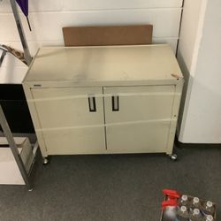 ROLLING METAL CABINET WITH TWO METAL SHELVES , VERY STURDY AND WELL MADE.