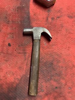 Based on similar vintage tools, this appears to be a antique or vintage hand-forged hammer with a wood handle.