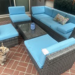 Rattan patio set and table one couch, three chairs and one center table and cushions