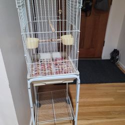 BIRD CAGE WITH STAND ON WHEELS  PLUS DISHES IN GOOD CONDITION 