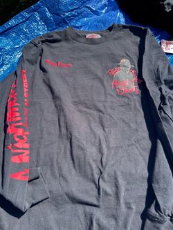 A Nightmare on Elm Street long-sleeve graphic t-shirt featuring a red "Freddy Krueger" signature and graphic on the chest and sleeve