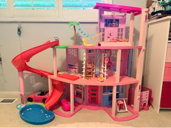 Barbie dream house with car, lots of Barbie’s and accessories/clothes!