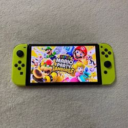 NINTENDO SWITCH OLED with 125 GAMES MARIO JAMBOREE,POKEMON,MARIO KART,ZELDA,MORTAL KOMBAT and Many More