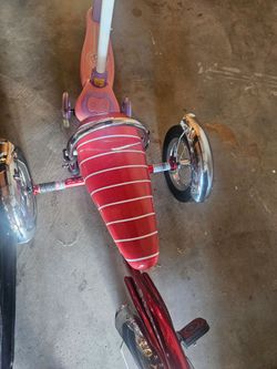 Red tricycle for a child schwin