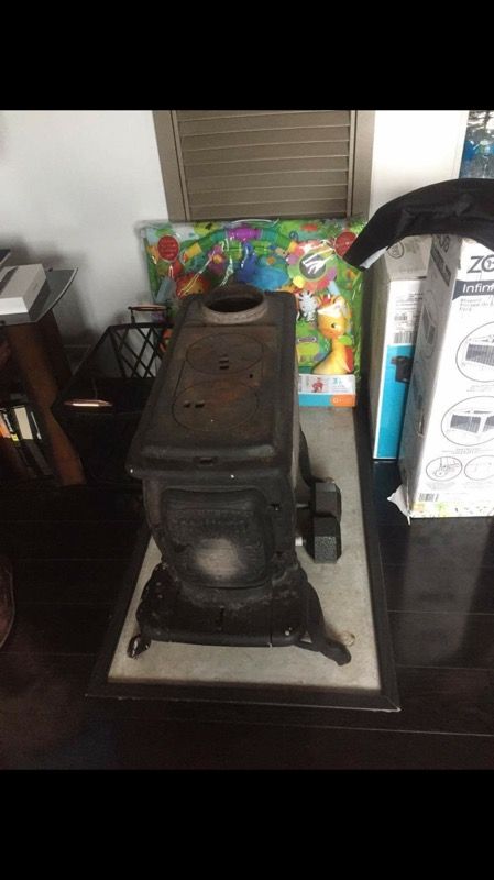 Vintage antique cast iron liberty bell wood burning stove