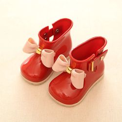 Red jelly boots with minor stains