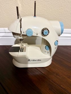 Mini Sewing Machine. Includes Foot Pedal, Power Adapter, 2 Bobbins, Operation Manual