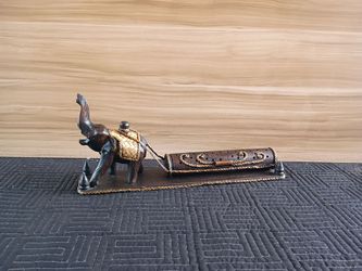 Thai elephant towing a log incense holder