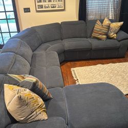 Reclining sectional sofa with a trundle
