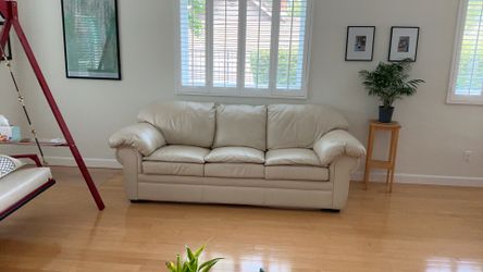 Leather sofa, converts to queen bed, clean, no stains, cream colored