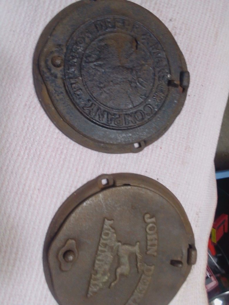 2- Antique JOHN DEERE & MANSUR Co CAST IRON Corn Planter Lid.

 FARM ADVERTISING