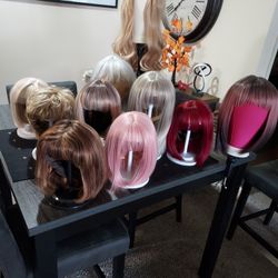 PRICED TO SELL 11 NEW UNUSED WIGS WITH 9 STYLING STANDS