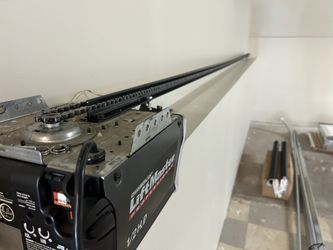 Garage door opener has an extra long carrying rod for a big garage door hardly ever used