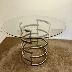 Arkesha Round Glass Top Metal Base Dining Table from Wayfair