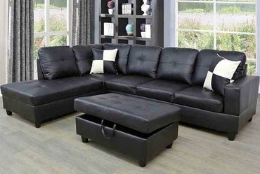 Black leather sectional couch and ottoman