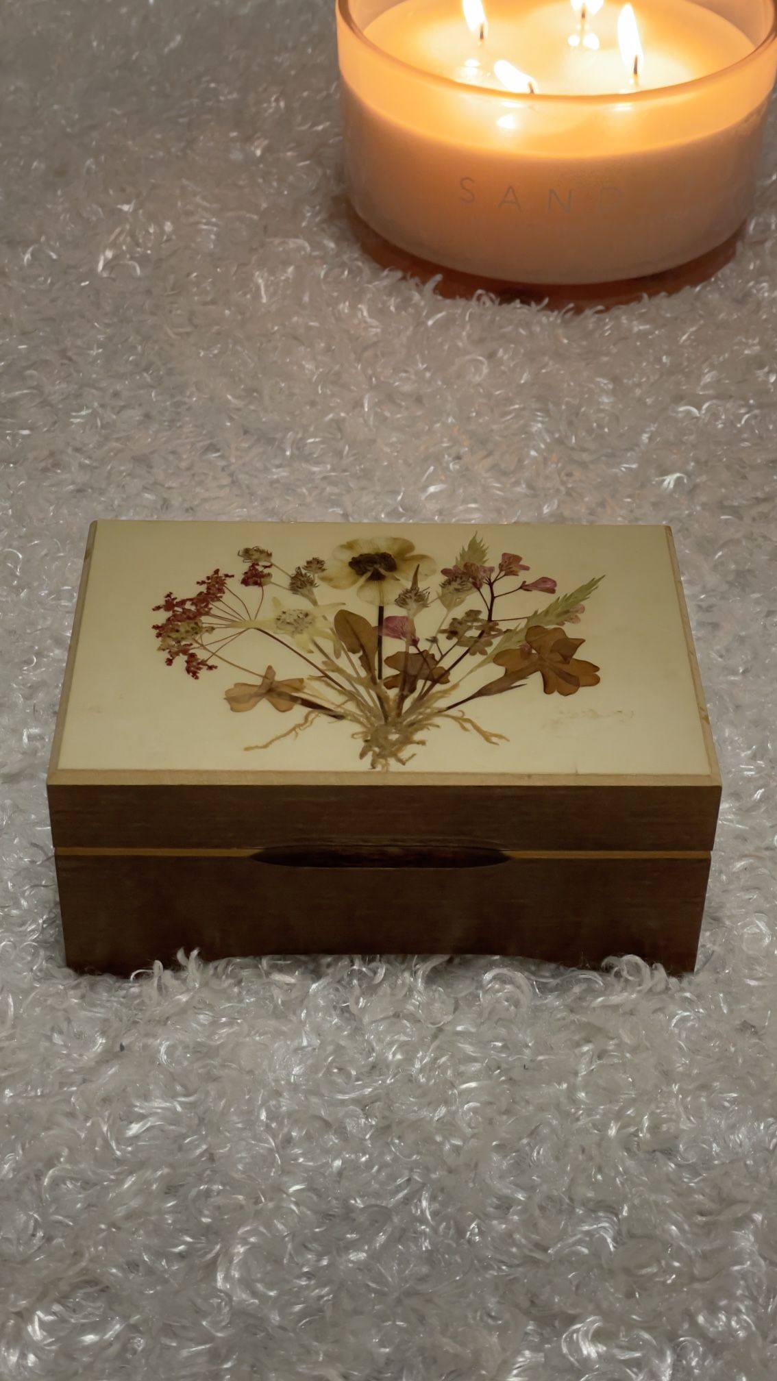 Vintage Reuge Swiss trinket music box with pressed flowers on the lid.