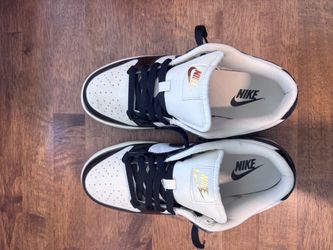 Black and white dunks with brown bottom with accent designs