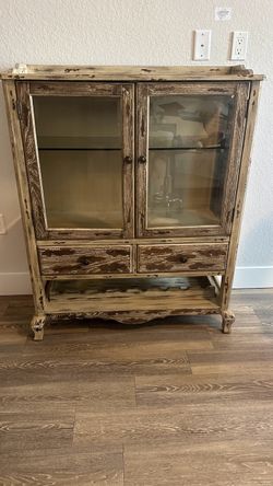 distressed farmhouse-style hutch or rustic china cabinet.