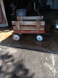 Radio flyer.\nVintage wagon with side rails , good rims and tires rolls great , perfect swap meet , Hauller