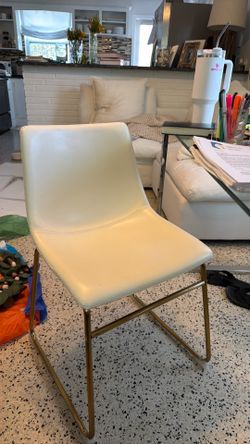 Set of two cream leather chairs w gold legs