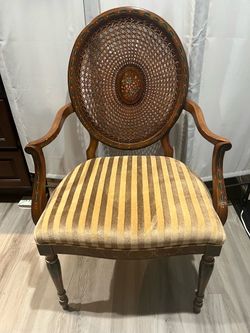 Antique rattan arm chair in brown
