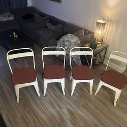 Four White Metal Chairs