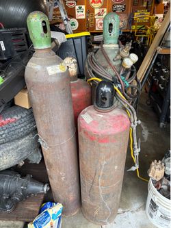 Oxygen and acetylene tanks big large ones and torch set up