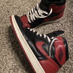of Nike Air Jordan 1 Retro High OG NRG "Homage to Home" sneakers in a black, red, and white leather colorway