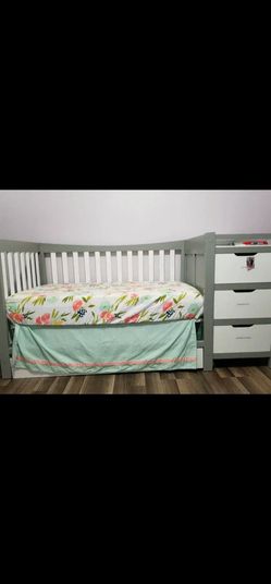 Grey and white Graco crib that converts to toddler bed