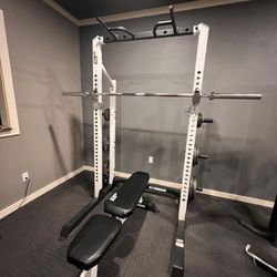 Weightlifting Rack W/ Olympic weight set and Utility bench.