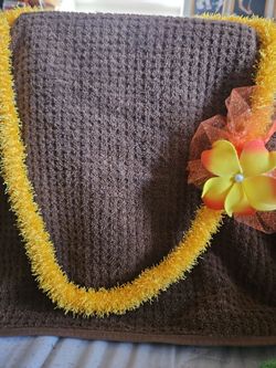 Yellow Tinsel Lei with Flower Accent