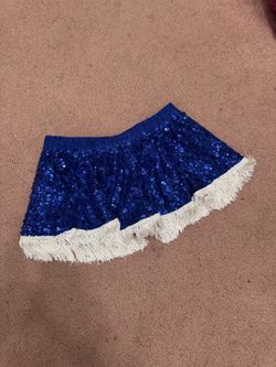 Bold royal blue sequin skird with playful white fringe trim. Elastic waistband for easy wear. Sparkling finish perfect for events and festivals. New