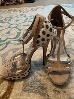 Women’s tan and cow print heels
