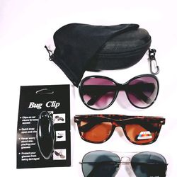 Ladies sunglass gift set. 3 pairs of sunglasses, visor clip and a black nylon sunglass case and microfiber bag.