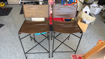 Two leather/black iron counter height bar stools.