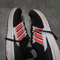 The Adidas UBounce DNA running sneakers in the Core Black/Solar Red colorway Size 8 are stylish low top sneakers designed for athletic activities and 