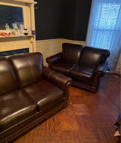 Brown leather couch and love seat
