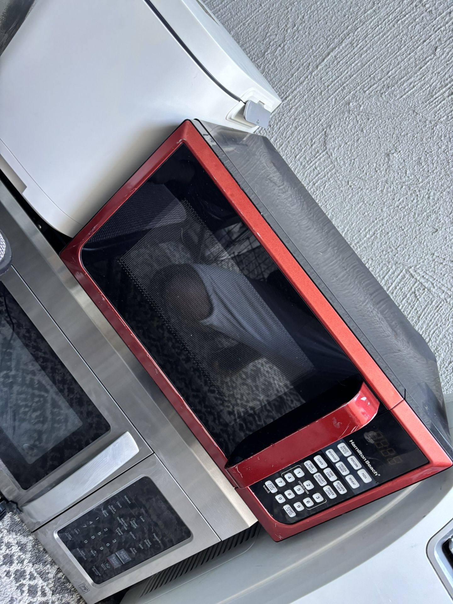 red Hamilton Beach countertop microwave oven.