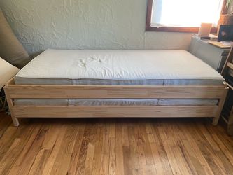 IKEA stackable twin beds with mattresses and covers