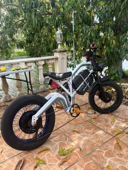 55mph. 50 miles range  Ebike dual motor