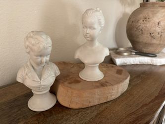 White porcelain busts of young boy and girl