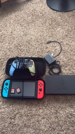 Nintendo Switch Console with controller, charger, Mario cart and carnival, and case