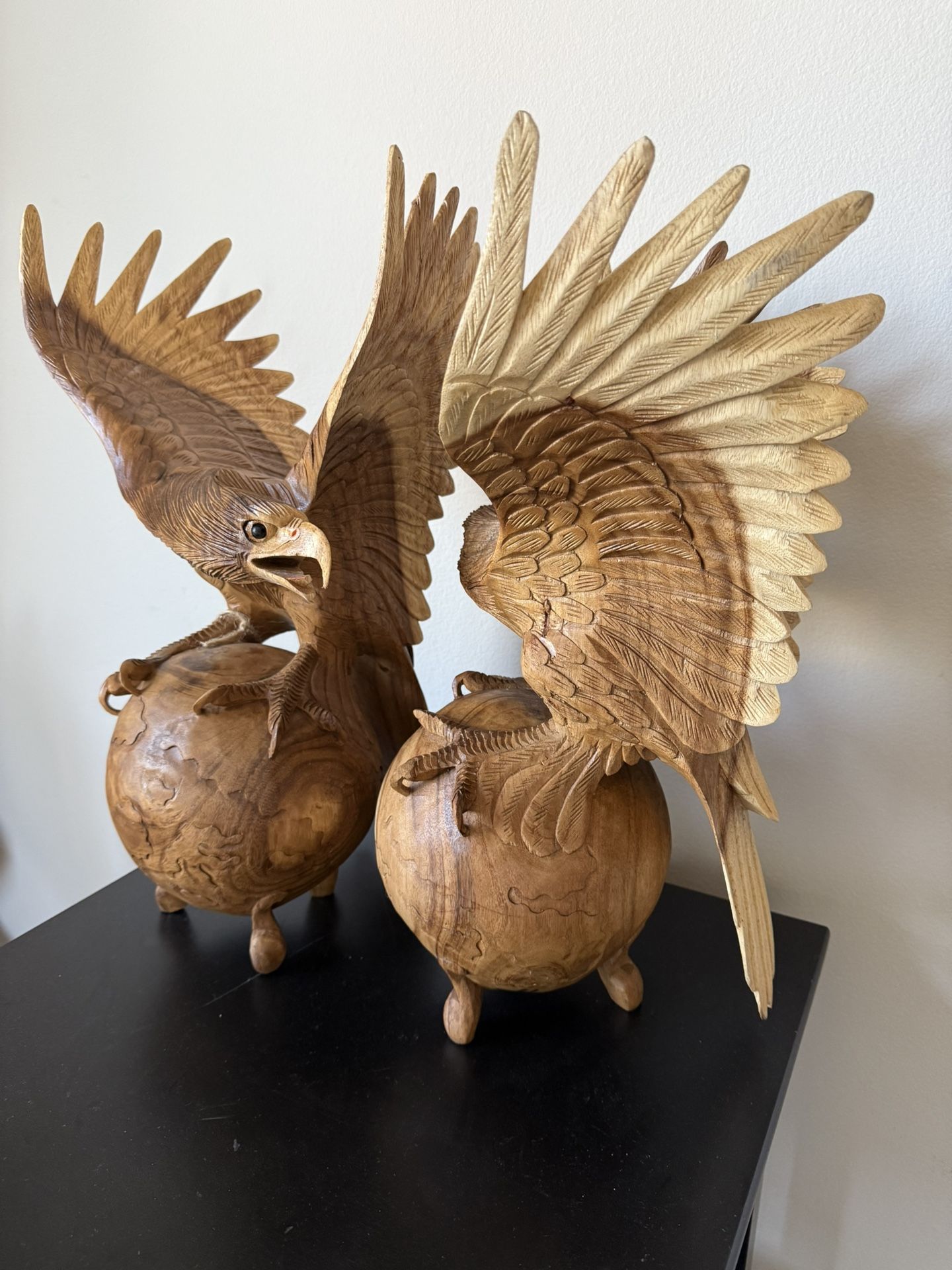 “Collectible Wooden Eagle Sculptures on World Globe”