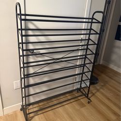 Black shoe rack with wheels. Dimensions: 44” L x 60” H