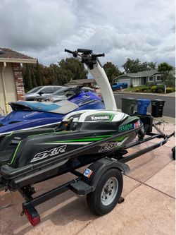 2 jet skies and a trailer