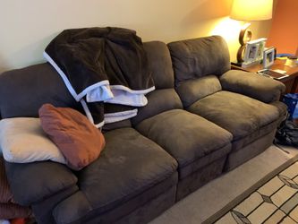 Good condition dark brown reclining couch and loveseat pair