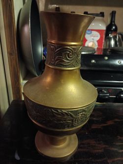 Vintage brass vase featuring intricate etched or engraved floral patterns for sale.