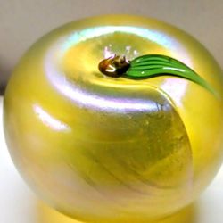 This art glass paperweight apple by Orient & Flume has a beautiful aurene gold green color. The paperweight is a little under 3" Tall