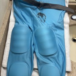 Blue Size Medium pants are integrated football practice pants featuring sewn-in pads for protection.