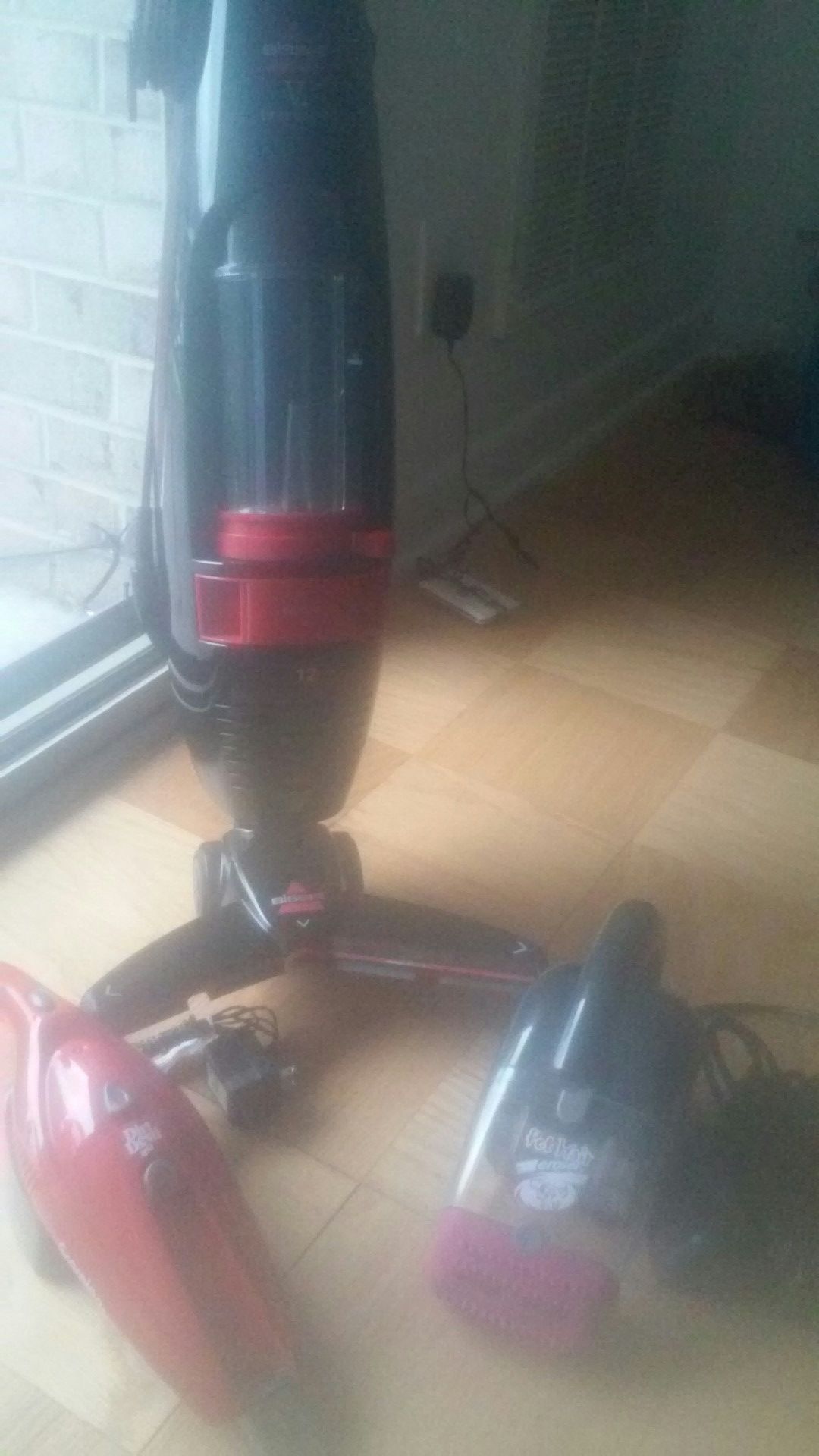 Bissell lightweight vacuum along with pet vac and Dirt Devil handheld vacuum